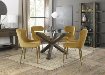 Bentley Designs Turin Glass 4 Seater Round Dining Table Dark Oak Legs with 4 Cezanne Mustard Velvet Chairs - Gold Legs