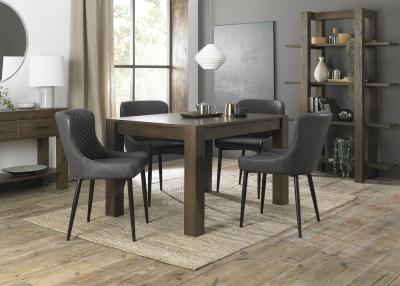 Product photograph of Bentley Designs Turin Dark Oak 4-6 Seater Extending Dining Table With 4 Cezanne Dark Grey Faux Leather Chairs - Sand Black Legs from Choice Furniture Superstore