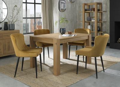 Product photograph of Bentley Designs Turin Light Oak 4-6 Seater Extending Dining Table With 4 Cezanne Mustard Velvet Chairs - Black Legs from Choice Furniture Superstore