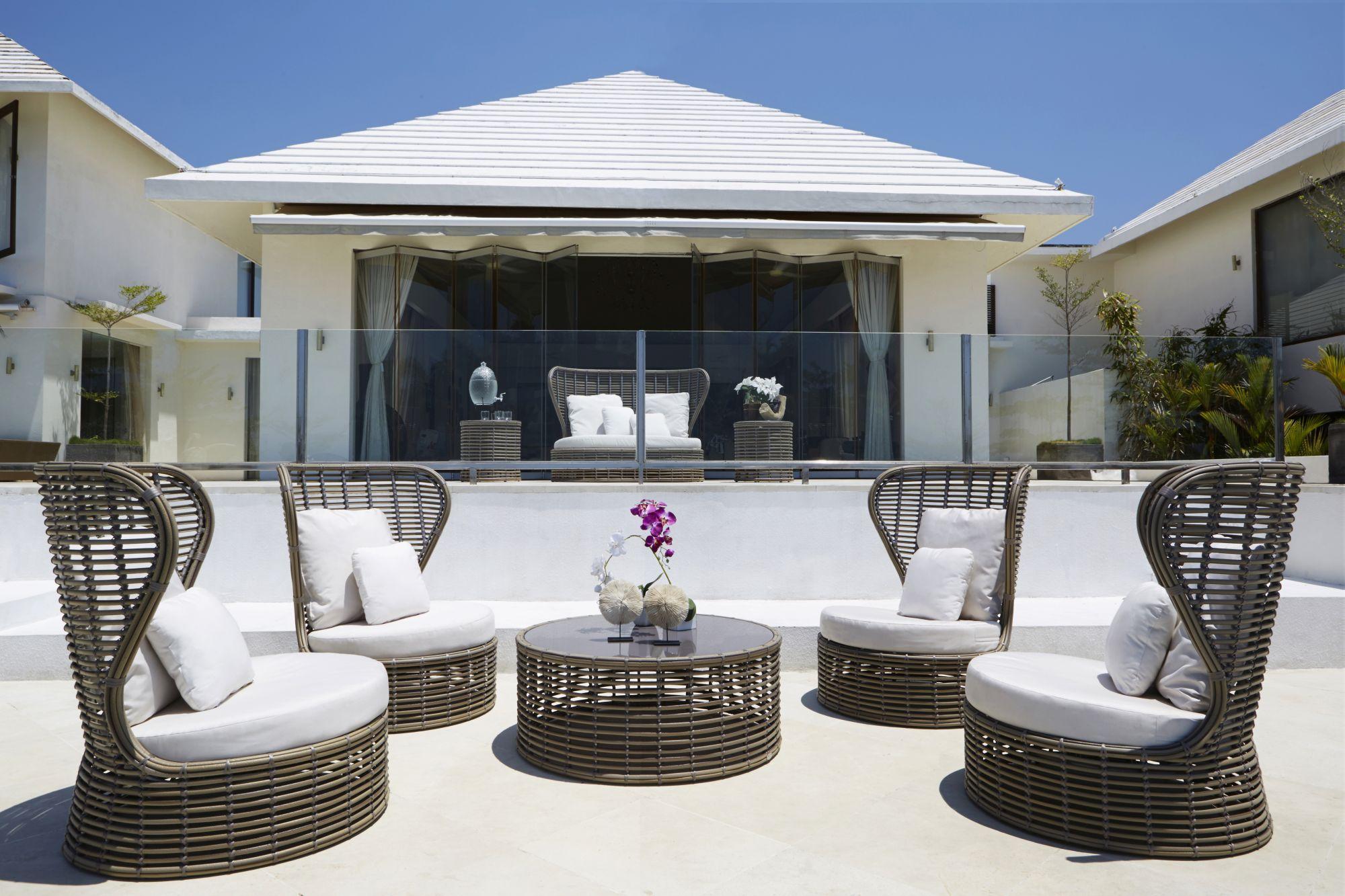 Product photograph of Skyline Bakari Walnut Rattan And Glass Top Outdoor Round Coffee Table from Choice Furniture Superstore.