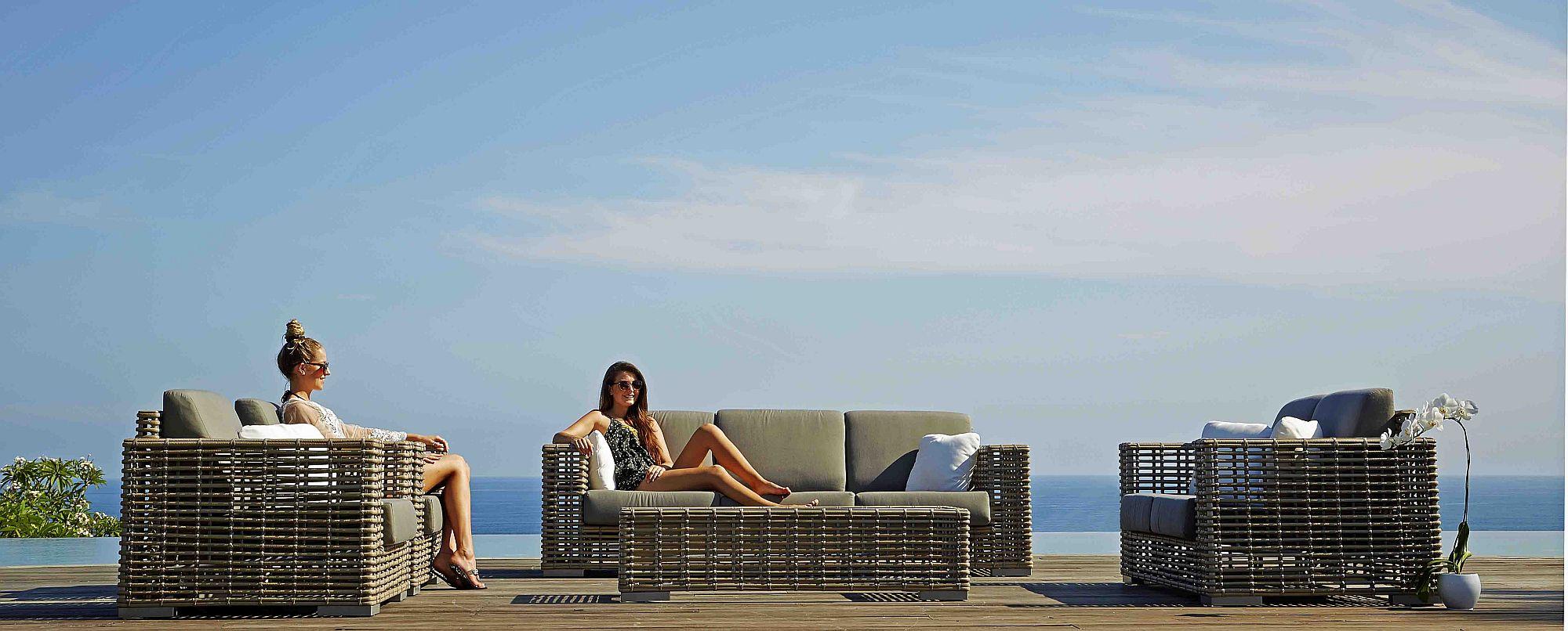 Product photograph of Skyline Castries Walnut Rattan Outdoor 2 Seater Sofa from Choice Furniture Superstore.