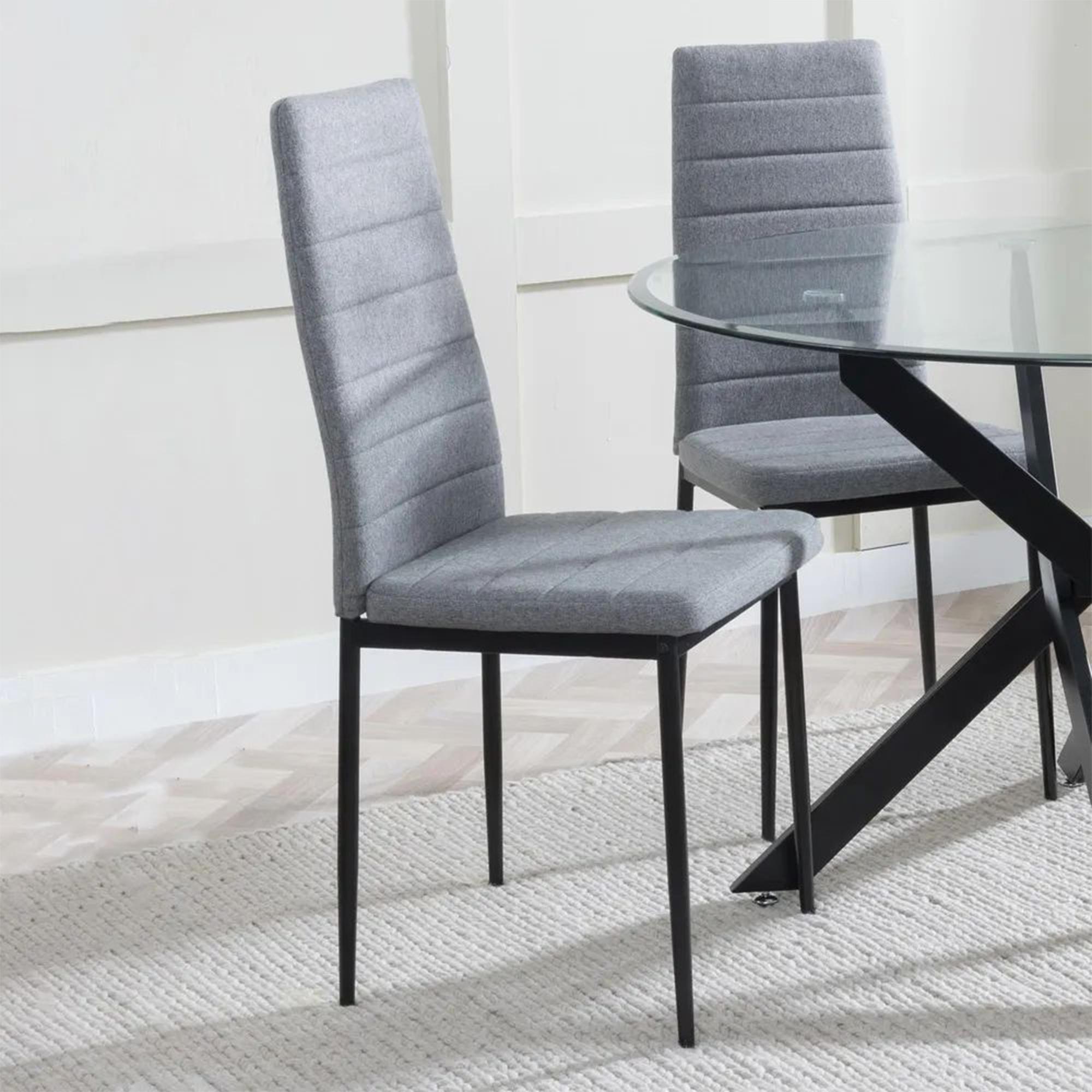 Product photograph of Chopstick Clear Glass And Black Metal Dining Set - Lido Dark Grey Fabric Chairs With Black Legs from Choice Furniture Superstore.