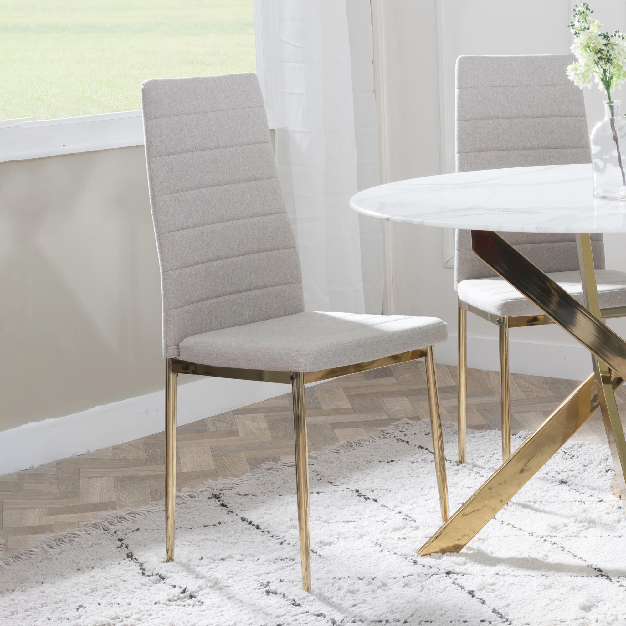 Product photograph of Chopstick Clear Glass And Gold Metal 4 Seater Round Dining Set - 2 Lido Sand Fabric Chairs With Gold Legs - Get 2 Chairs Free from Choice Furniture Superstore.