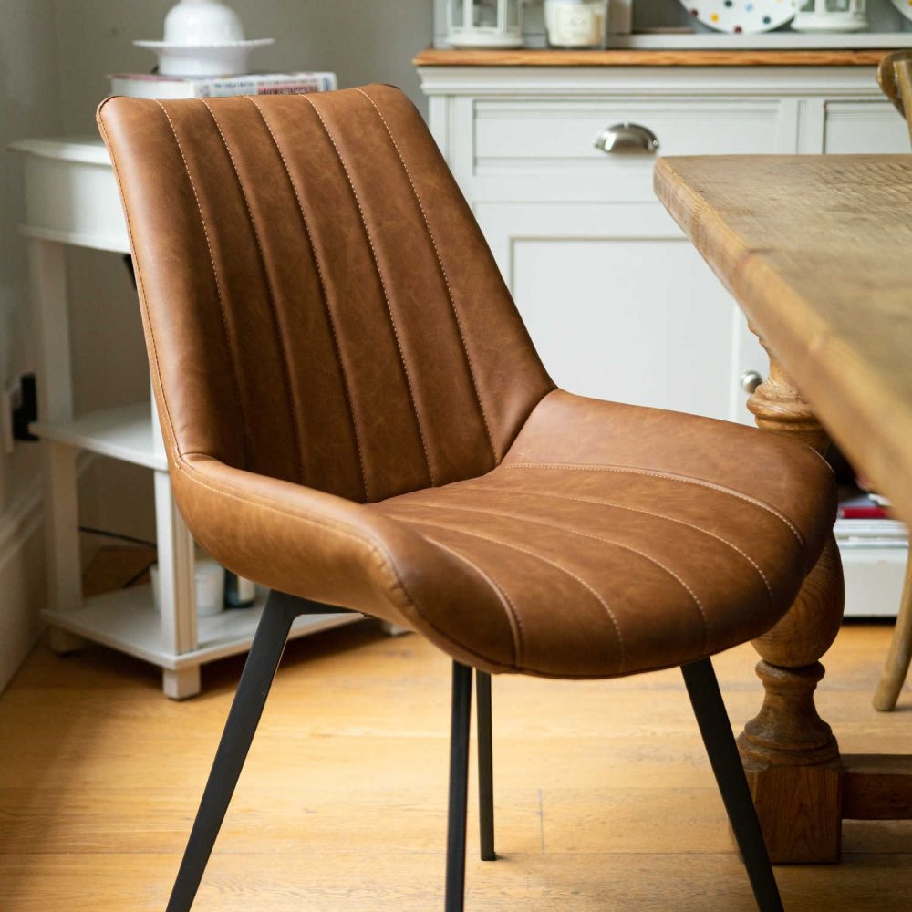 Product photograph of Casteel Tan Brown Faux Leather Dining Chair Sold In Pairs from Choice Furniture Superstore.