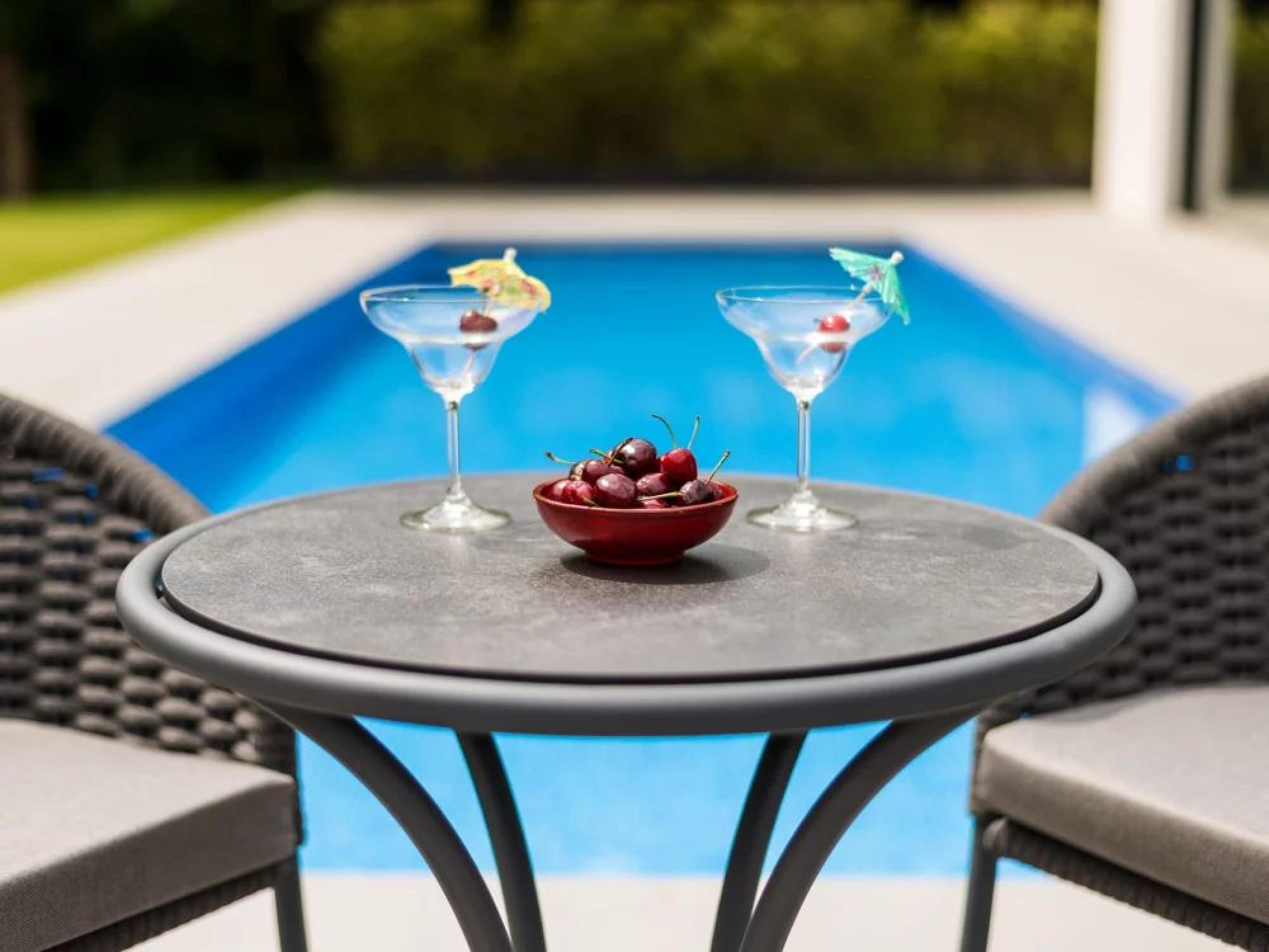 Product photograph of Alexander Rose Cordial Grey Bistro Table With Pebble Hpl Top from Choice Furniture Superstore.