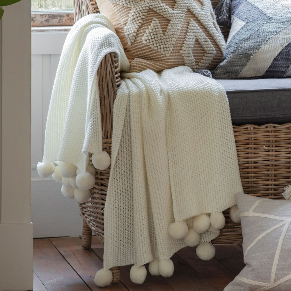 Product photograph of Rustic Moss Stitched Pom Pom Cream Fabric Throw from Choice Furniture Superstore.