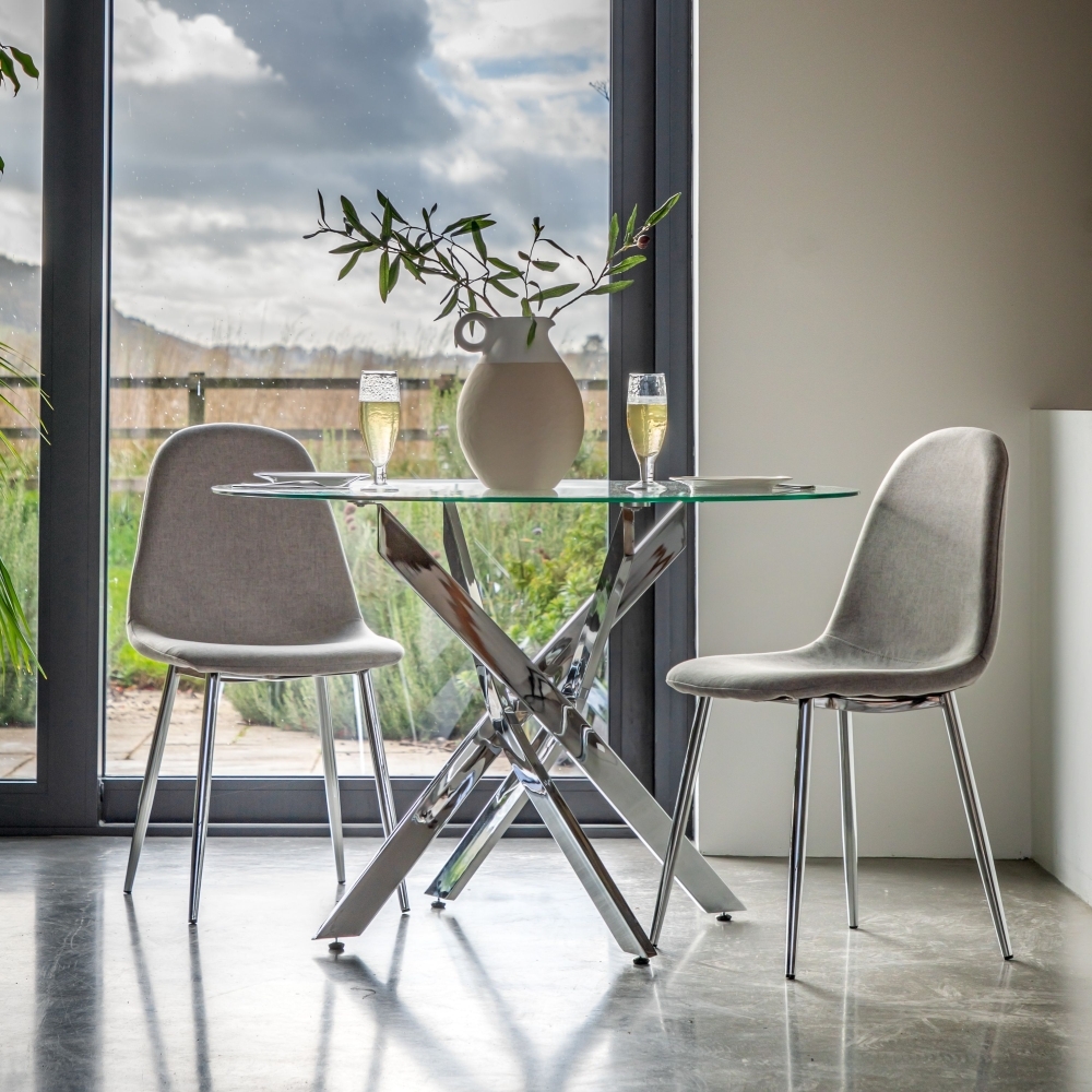 Product photograph of Ramsey 110cm Clear Glass And Chrome Round Dining Table from Choice Furniture Superstore.