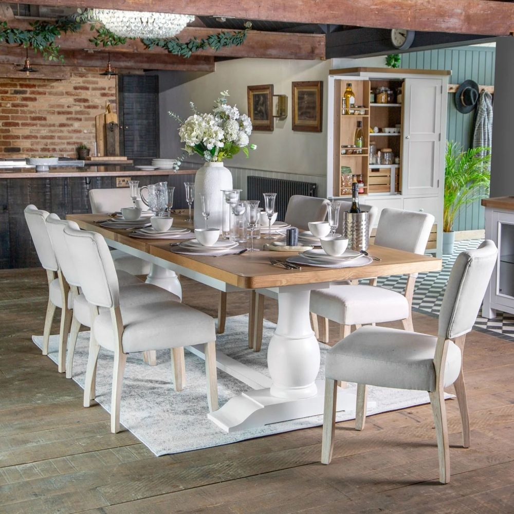 Product photograph of Clairton White 6-8 Seater Extending Pedestal Base Dining Set With 8 Natural Fabric Chairs from Choice Furniture Superstore.