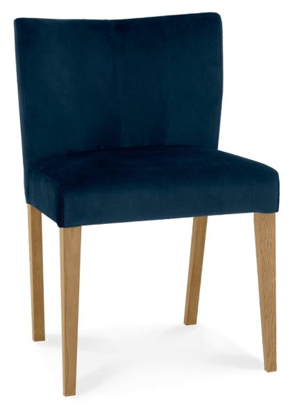 Product photograph of Bentley Designs Turin Light Oak Low Back Dark Blue Velvet Fabric Dining Chair Sold In Pairs from Choice Furniture Superstore.