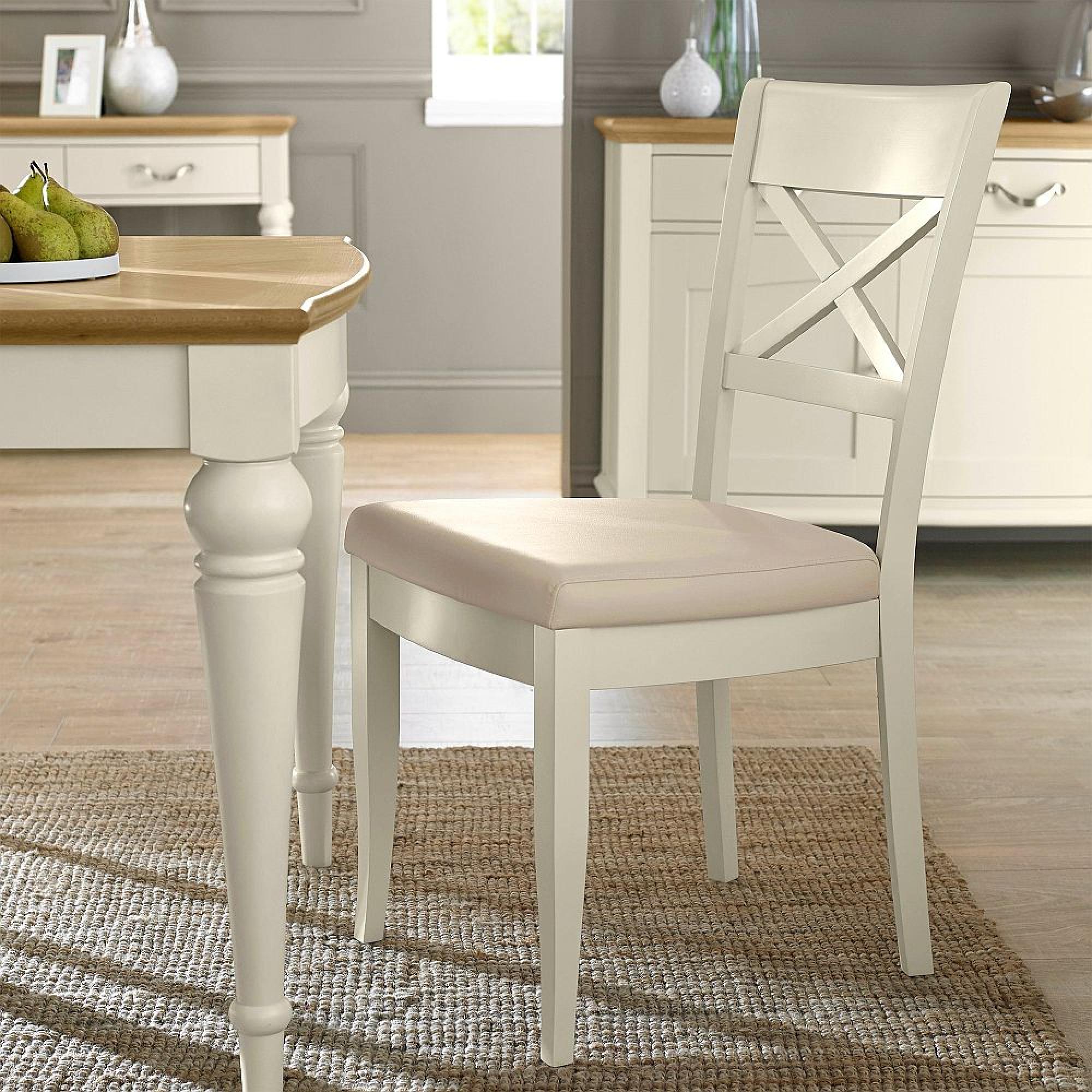 Product photograph of Bentley Designs Montreux Antique White And Ivory Bonded Leather Dining Chair - Sold In Pairs from Choice Furniture Superstore.